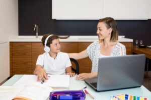 mother-helping-son-with-homework_23-2148622807